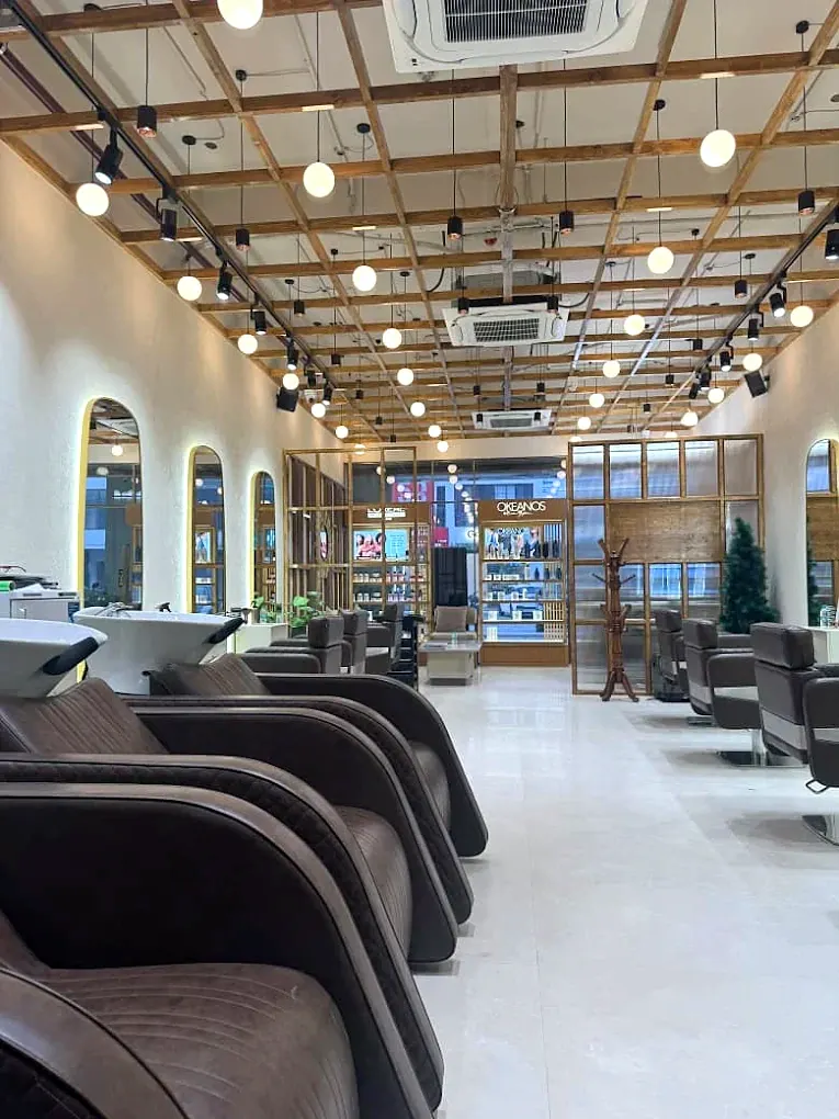 A sequence of salon chairs beneath warm overhead lights