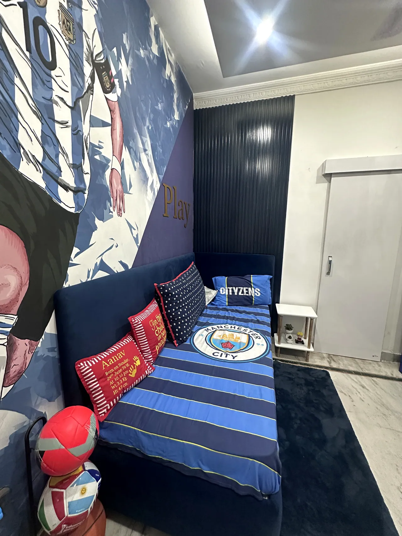 Closer view of the football mural, bed and themed bedding