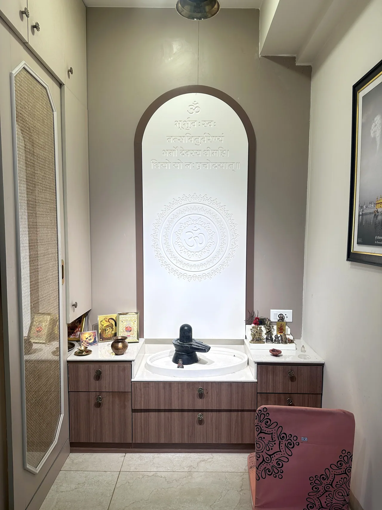 Dedicated puja alcove with a softly lit counter