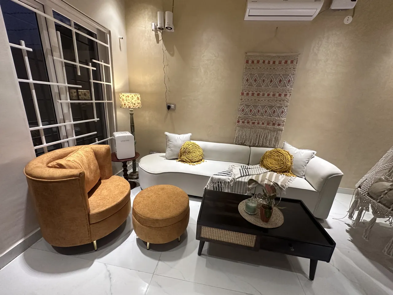 Soft seating and circular ottomans in the apartment living room