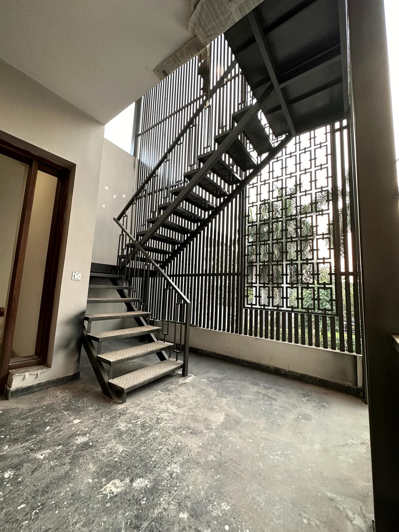 Staircase and landing with metal balustrade and daylight