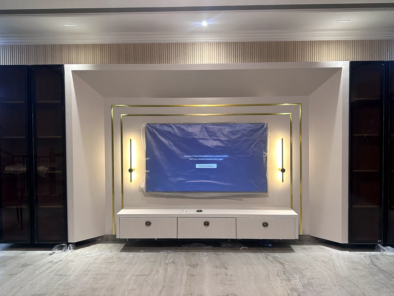 Feature media wall with decorative lighting and display cabinetry