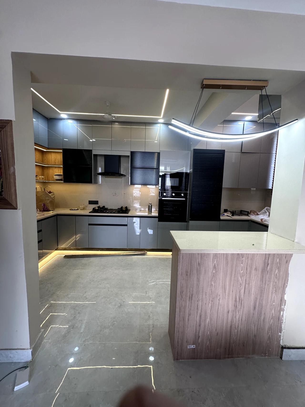 Kitchen cabinetry and counter detail with integrated lighting