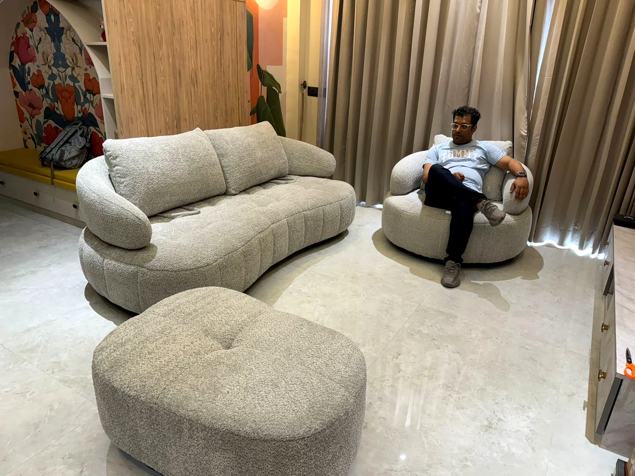 Sculptural curved sofa and accent chair in the family lounge