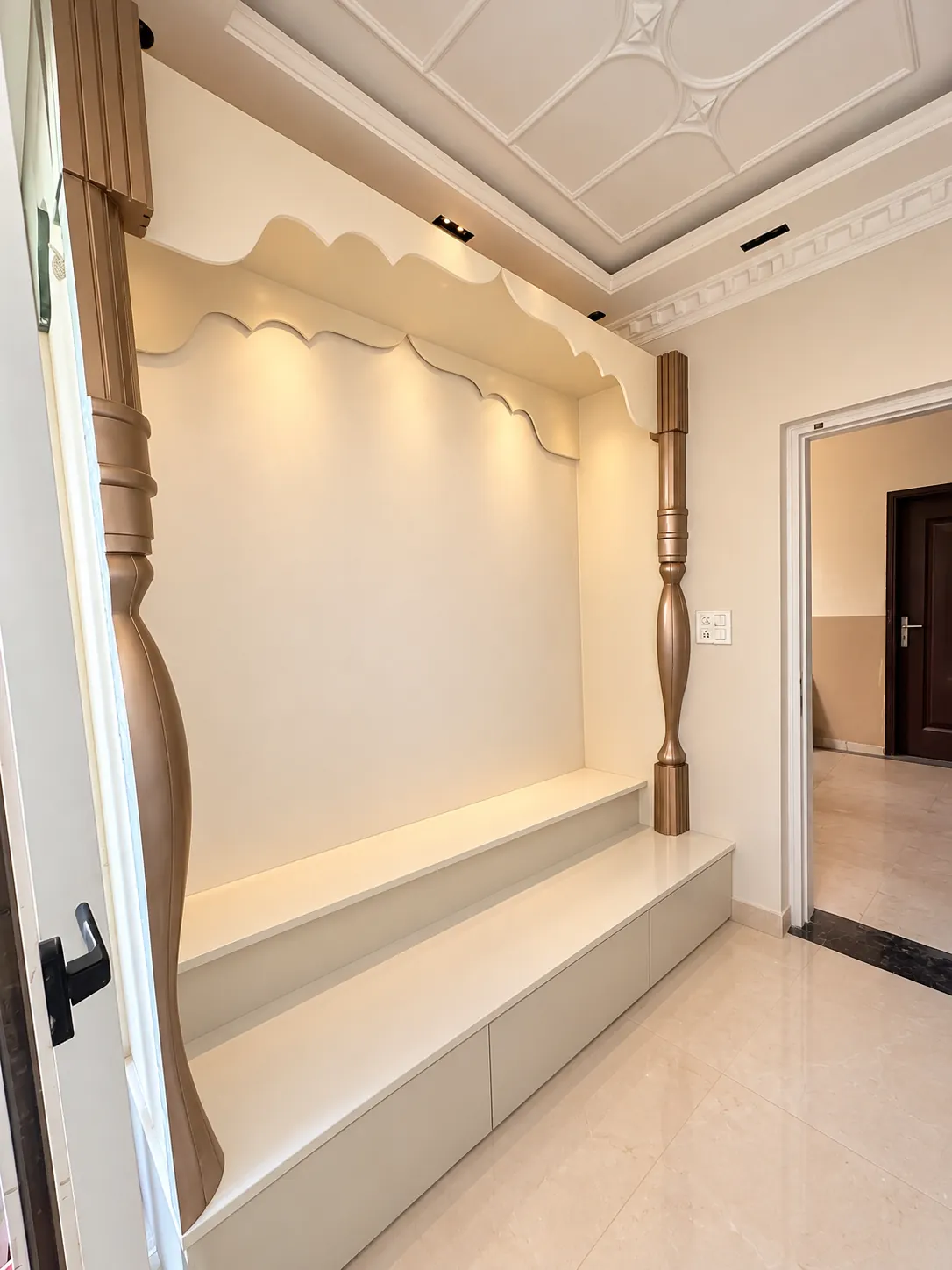 Finished mandir alcove with its scalloped arch and carved columns
